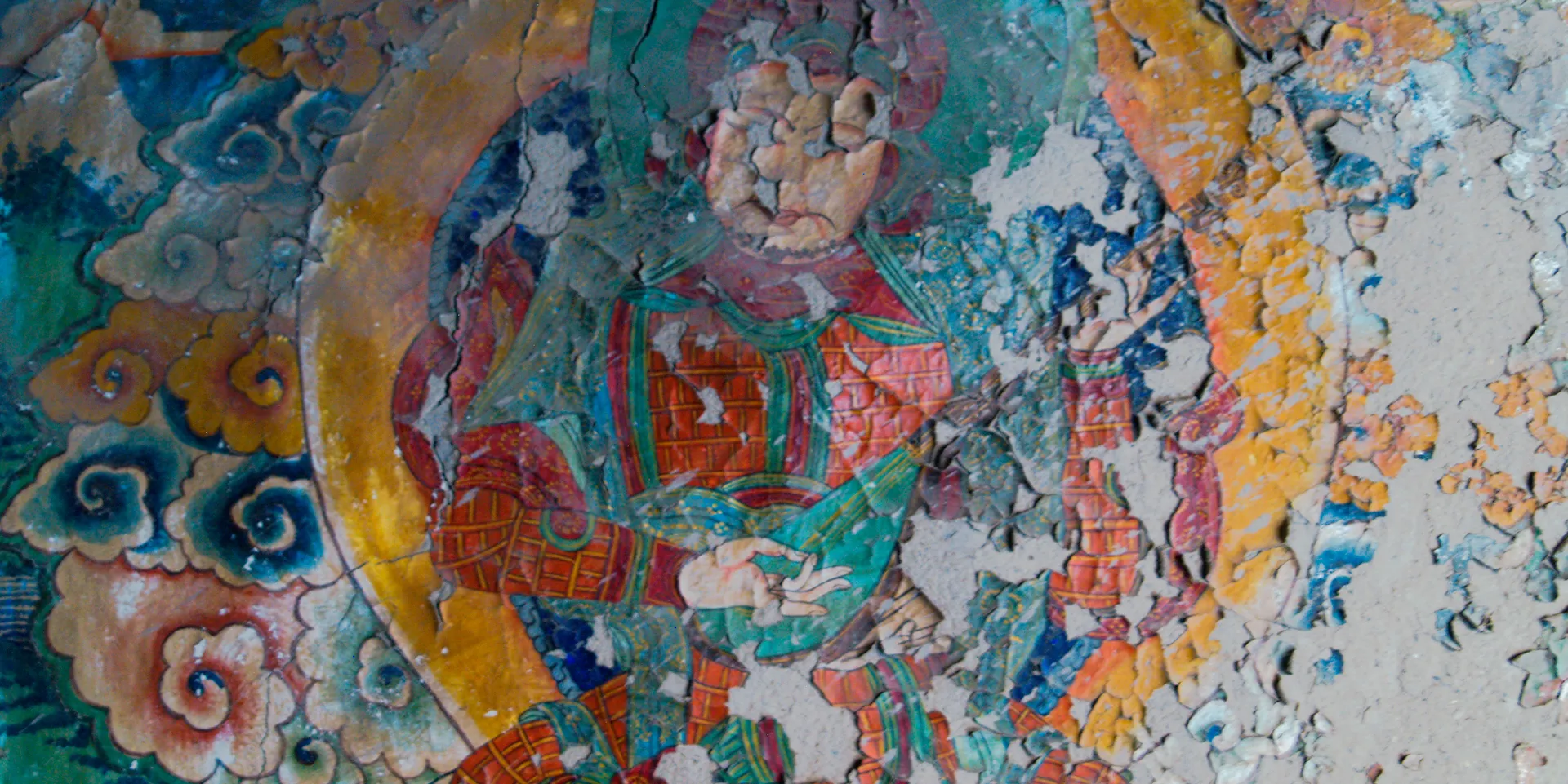 An old wall mural worn by time & weather in Upper Mustang